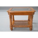 A modern stained frame coffee table having glazed top and bergere canework undertier, approx 68 x