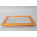 A modern pine wall mirror, approx. 92 x 67cm