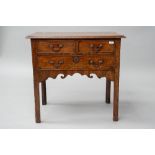 A 19th Century mahogany lowboy having two short over one long drawer, shaped apron and square