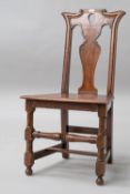 A 19th Century oak hall chair having flared shoulder and teardrop vase back solid seat and turned