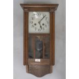 An early 20th Century oak cased wall clock, silvered dial named Wilson, Penrith, length approx.