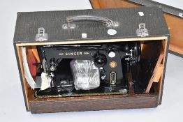 A vintage Singer sewing machine in integral wooden case, with Crocodile effect finish , model
