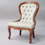 A reproduction nursing chair having stained frame and button back , upholstered in jade green ,