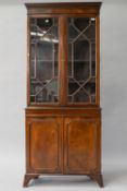 A reproduction Regency style mahogany bookcase , having greek key style decoration to cornice,