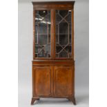 A reproduction Regency style mahogany bookcase , having greek key style decoration to cornice,