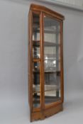 A late 19th or early 20th Century walnut corner display, possibly a shop fitting, comprising full