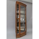 A late 19th or early 20th Century walnut corner display, possibly a shop fitting, comprising full