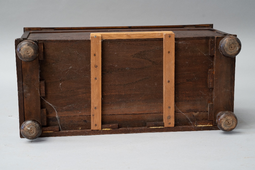 An early 20th Century oak panelled kist/bedding box having applique decoration, on bun feet, - Image 4 of 4