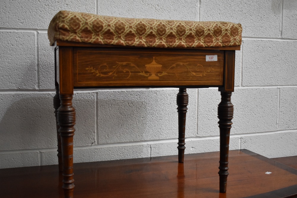 An Edwardian mahogany piano stool having classic satinwood inlay and upholstered seat, on turned