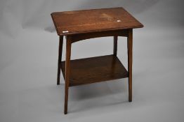 An early 20th Century oak side table having canted top and plain undertier, splay square tapered