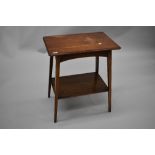 An early 20th Century oak side table having canted top and plain undertier, splay square tapered