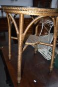 A vintage circular top occasional table having Lloyd Loom frame and undertier, diameter approx.