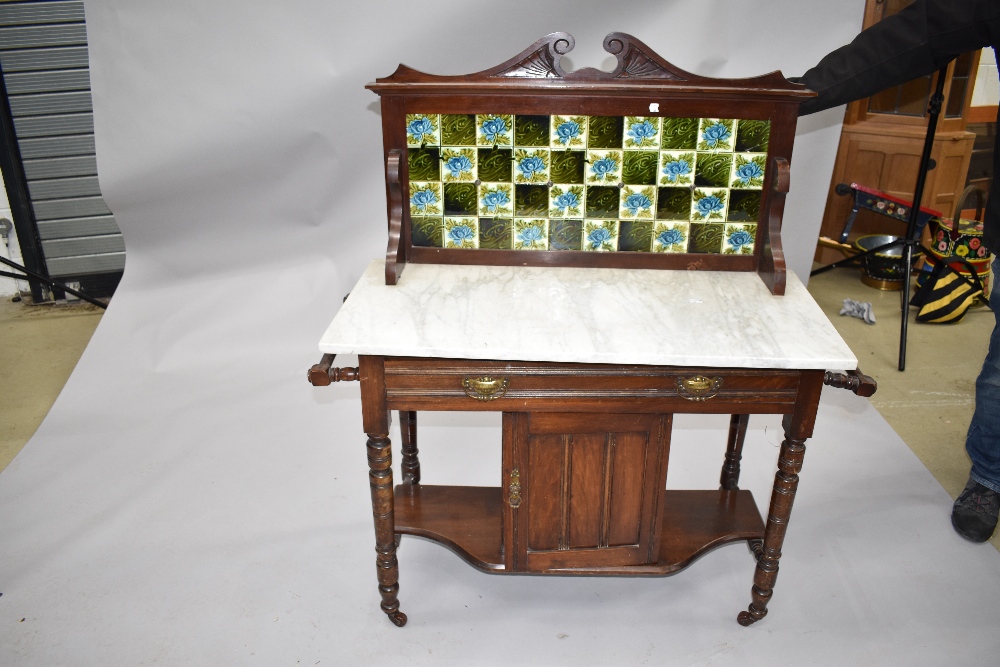 A Victorian stained frame wash stand having tiled back , marble top , double frieze drawers and