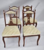 A set of four late Victorian dining chairs having fan back and carving to neck, seats and part