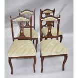 A set of four late Victorian dining chairs having fan back and carving to neck, seats and part