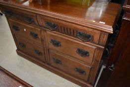 A Victorian mahogany sideboard base having ornate handles on both the two frieze and the four