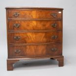 A 20th Century reproduction Regency style low chest of four long drawers having brass drop handles