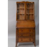 An early to mid 20th Century oak and ply bureau bookcase