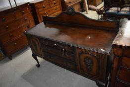 An early 20th century mahogany sideboard having foliate and shaped ledge back having gadrooned