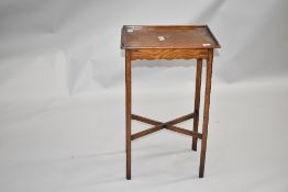 A late 19th oak side table in the Arts and Crafts style with ledge back and sides having shaped