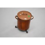 A copper coal or similar lidded bin having wrought iron fit, in the Arts and Crafts style,