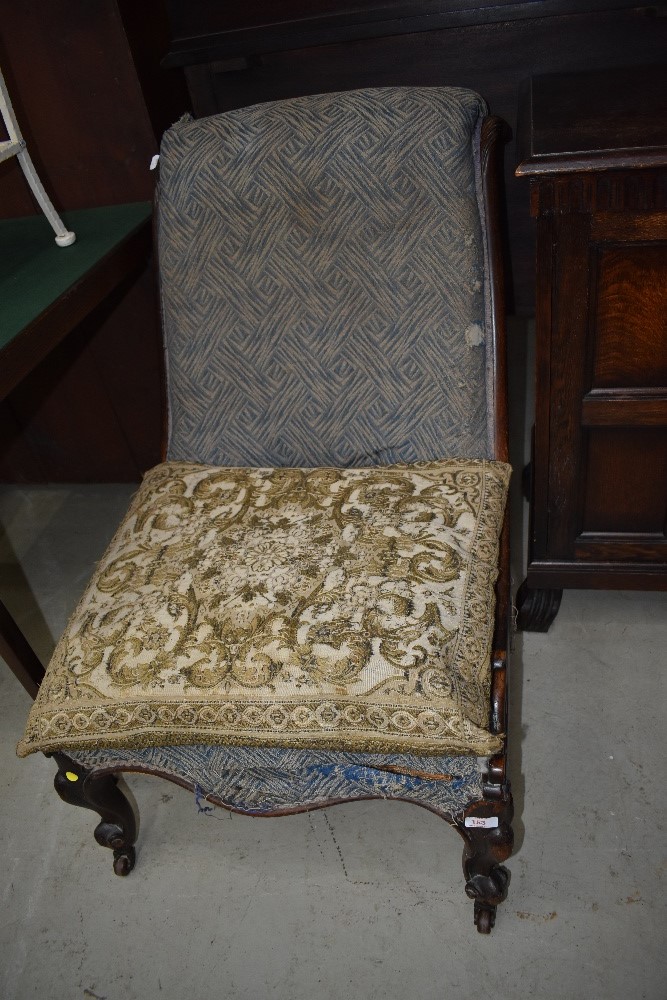 A 19th Century mahogany low seat nursing chair havimg knurl frame with scroll detail, quite a bit of