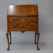 A mid 20th Century walnut bureau having interesting slide out internal stationery compartment , with
