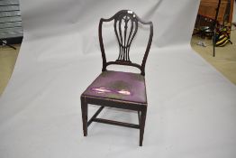 An early 20th Century single dining chair having slatted vase back and upholstered drop in seat with