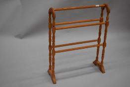 A reproduction pine towel rail in the traditonal form with turned frame