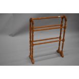 A reproduction pine towel rail in the traditonal form with turned frame