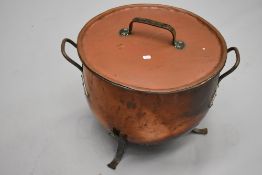 A large copper lidded cauldron , in the Arts and Crafts style, diameter approx 52cm, height 44cm