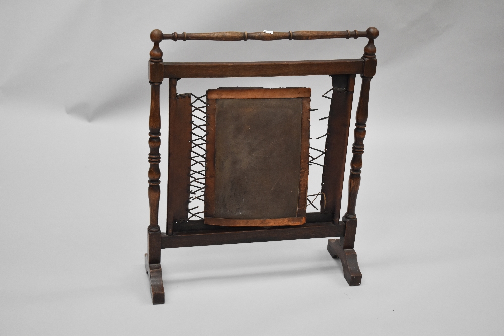 An early 20th Century firescreen having turned oak frame and tooled leather panel and strap work - Image 2 of 2