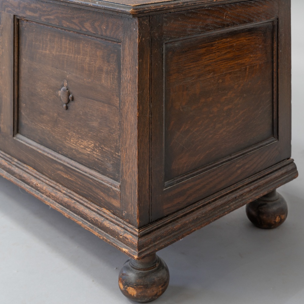 An early 20th Century oak panelled kist/bedding box having applique decoration, on bun feet, - Image 2 of 4