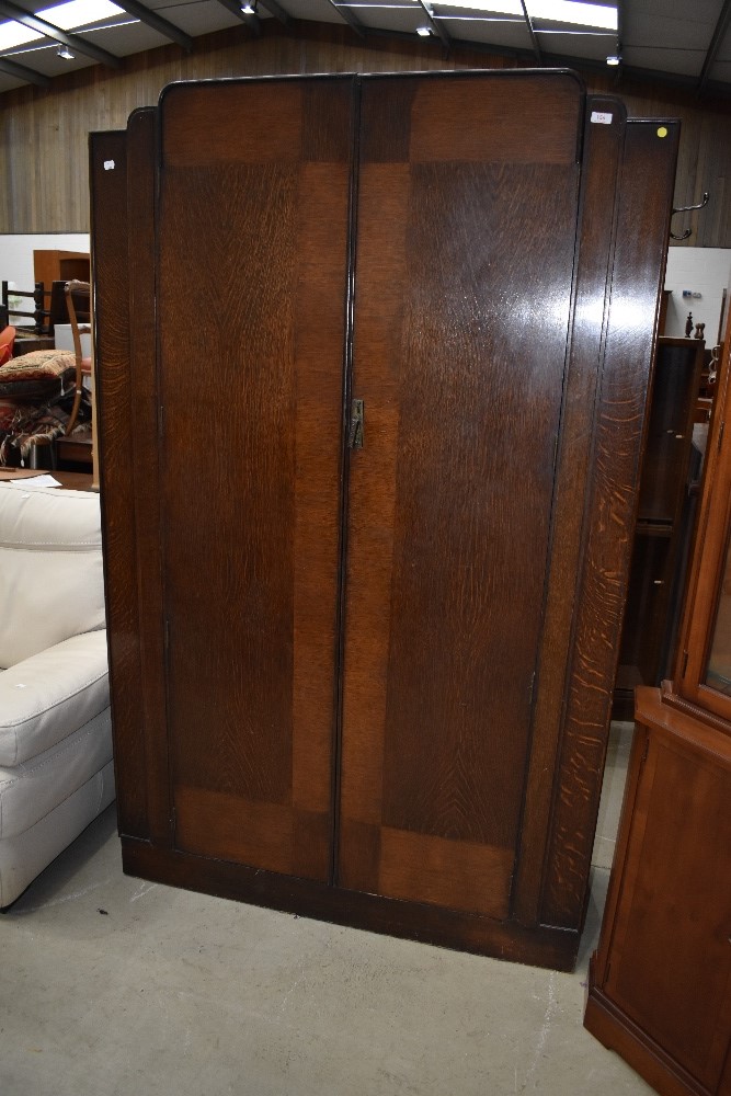 An early to mid 20th Century oak double wardrobe in a late Deco design, locked and no key, width