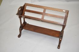 An early 20th Century mahogany book trough of slatted design, on turned frame with undershelf, width