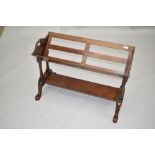 An early 20th Century mahogany book trough of slatted design, on turned frame with undershelf, width