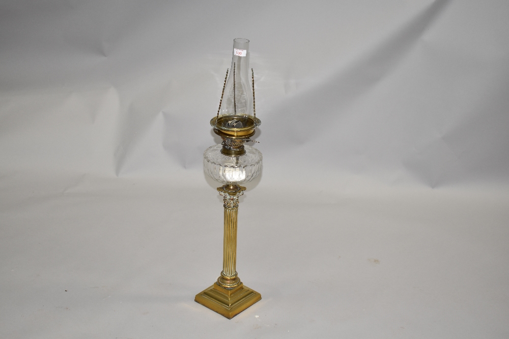 A late 19th or early 20th Century brass oil lamp having Corinthian column glass reservoir and