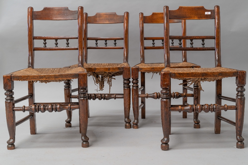 A set of four 19th Century spindle back kitchen chairs having rush seats, having rail and bobbin
