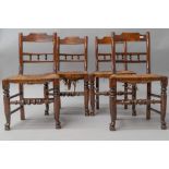 A set of four 19th Century spindle back kitchen chairs having rush seats, having rail and bobbin