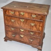 A period oak chest of three long burrwood fronted drawers with brass handles and escutcheons ,