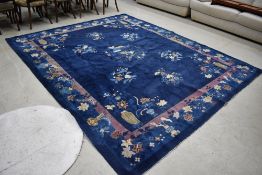 A traditional Oriental carpet square having blue ground with vase and naturalistic design, approx.