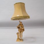A gilt metal table lamp modelled as a piper in traditional dress, detail includes feather cap and