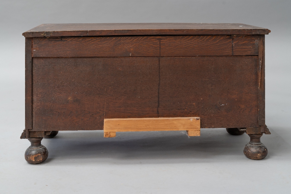 An early 20th Century oak panelled kist/bedding box having applique decoration, on bun feet, - Image 3 of 4