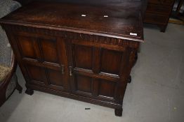 An early 20th Century oak side cabinet of shallow proportions having panelled doors , width