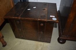 An Arts and Crafts style dark copper coal box, having band type detailing and twist handles