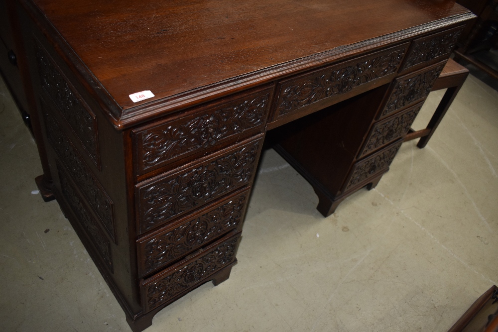 A 19th Century oak desk having extensively carved drawers, no keys but all drawers currently