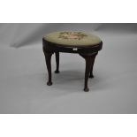 An early 20th Century Queen Anne style dressing table stool , of oval form with drop in