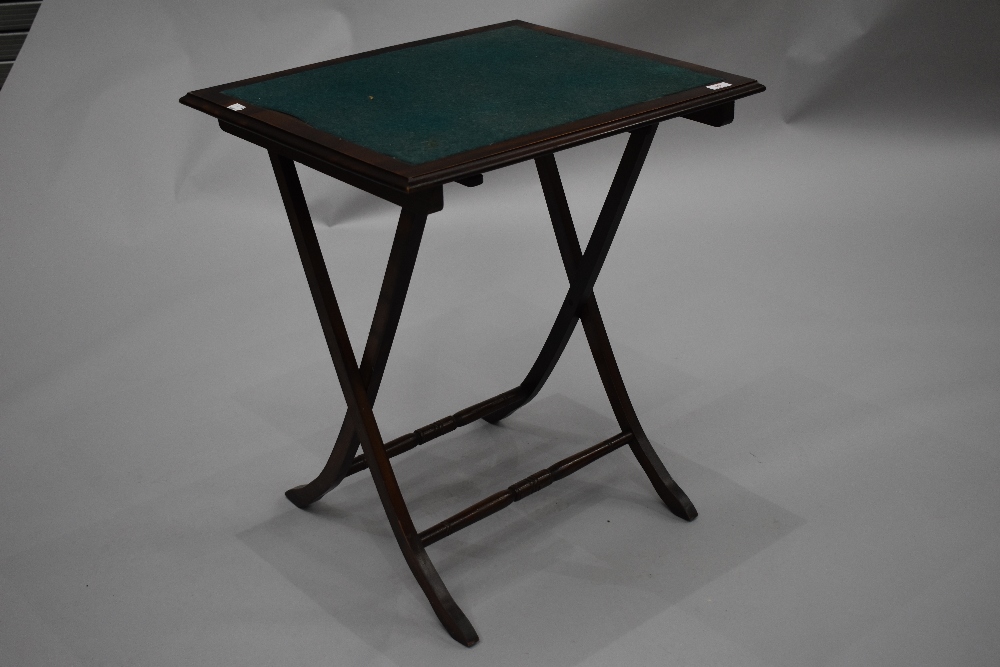 An early to mid 20th Century mahogany fold up card table on turned frame, approx. 61 x 50cm