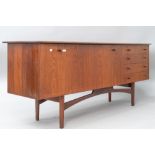 A vintage teak sideboard, in the Long John style , having wide drop flap cocktail or similar section