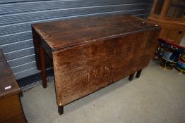 A 19th Century oak gateleg dining table, in poor condition with some signs of historical worm